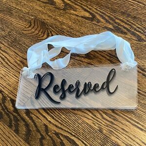 Clear Reserved Sign with Black Lettering
